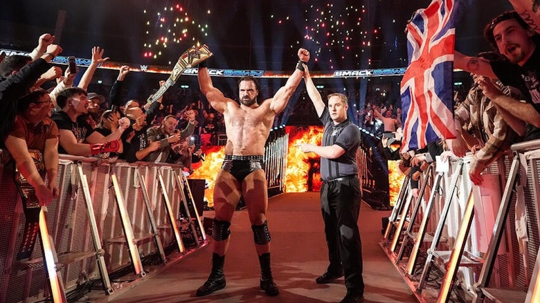 Drew McIntyre celebrates with the WWE title on 