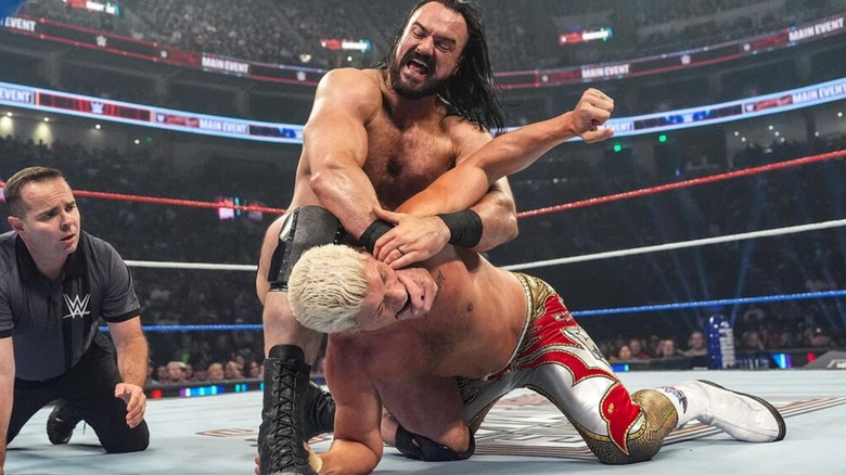 Drew McIntyre puts Cody Rhodes in a hold in the middle of the ring during their match at Saturday Night's Main Event.