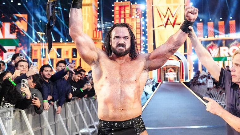 Drew McIntyre holding up the world title