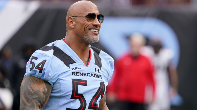 Dwayne Johnson wearing an XFL football jersey