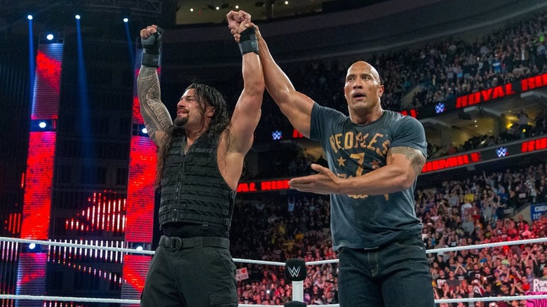 The Rock and Roмan Reigns celebrating