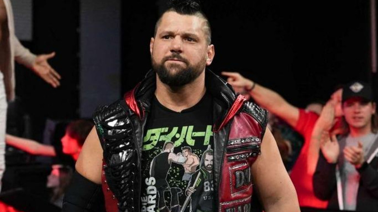 Eddie Edwards wearing a black and red vest jacket