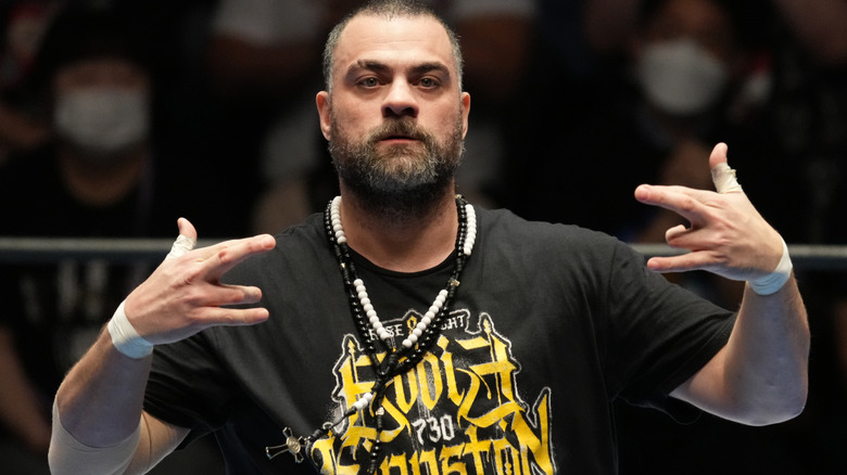 Eddie Kingston is wearing black and white necklaces