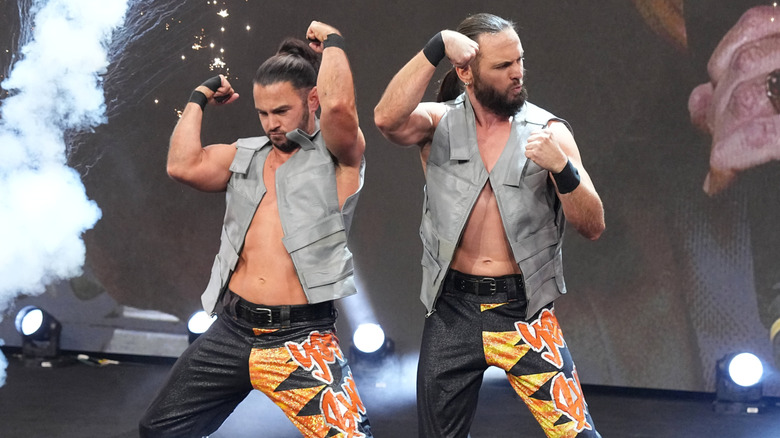 The Young Bucks pose on the stage during their entrance before a match on an episode of 