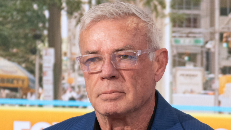 Eric Bischoff wearing clear-framed glasses