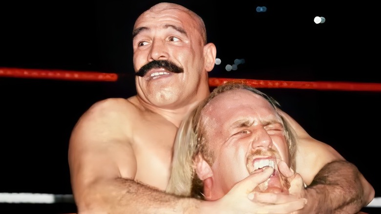 Iron Sheik puts the Camel Clutch on Hulk Hogan