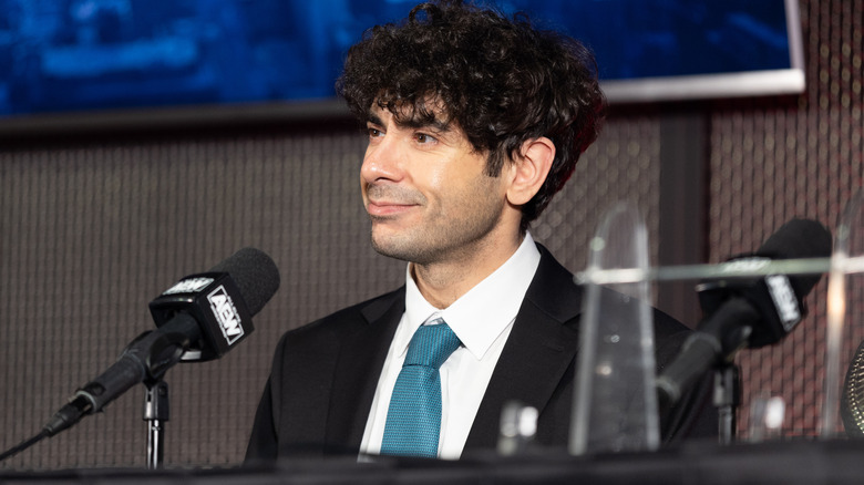 Tony Khan sitting at a microphone