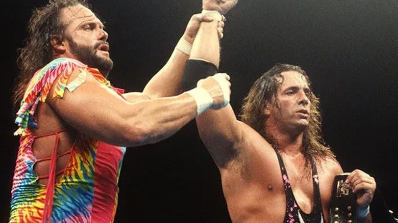 "Macho Man" Randy Savage lifts Bret Hart's hand after the latter emerged victorious