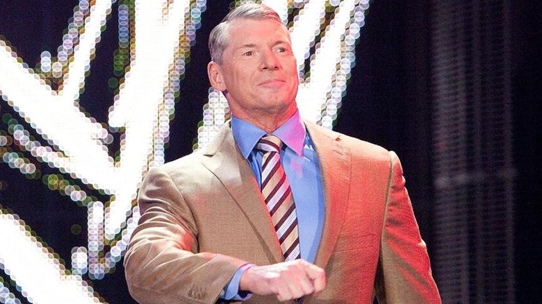 Vince McMahon strutting his way down to the ring during a WWE show.