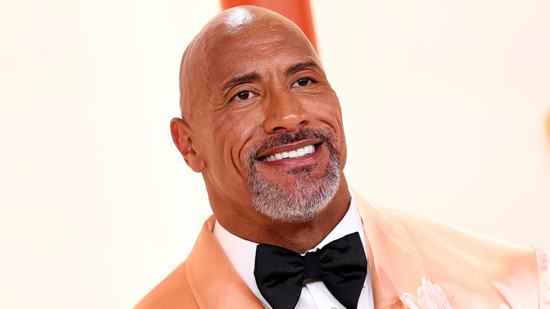 Dwayne Johnson smiles at a press event