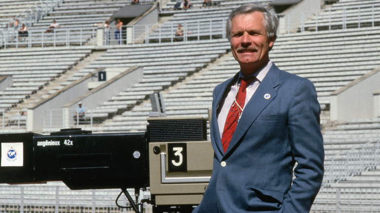 Former media mogul Ted Turner stands in front of a camera set
