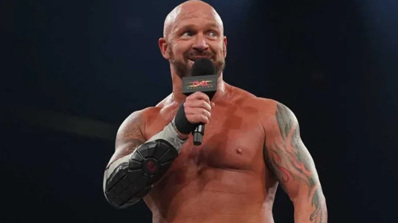 Eric Young holding a microphone