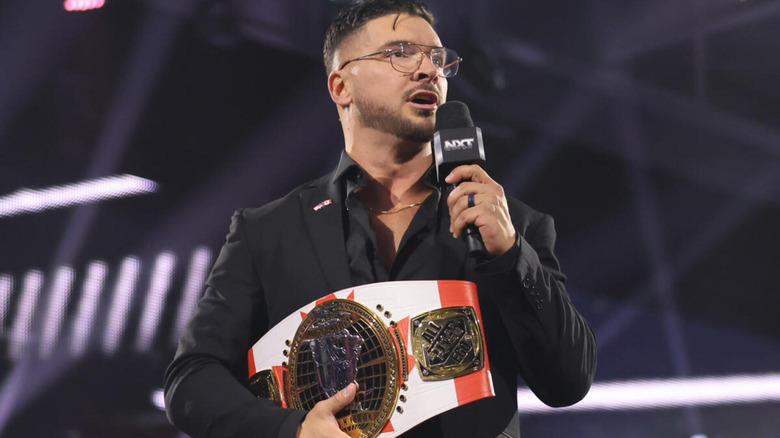 Ethan Page holds a Canadian-themed NXT North American Title as he speaks on the microphone.