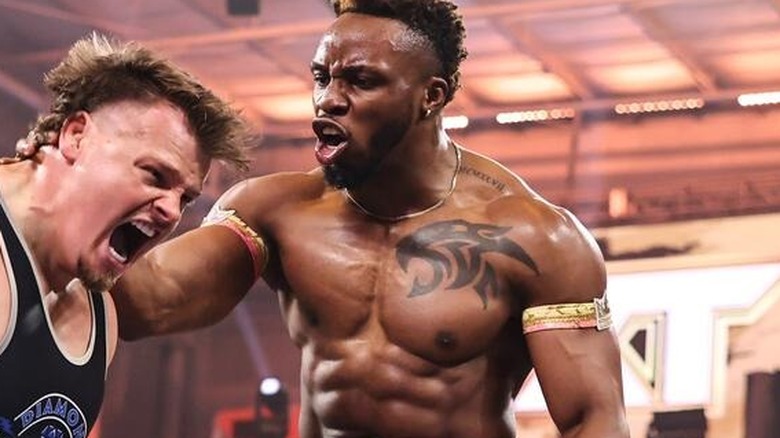 Edris Enofe grabs the neck of Brutus Creed in the ring during a match on "WWE NXT"