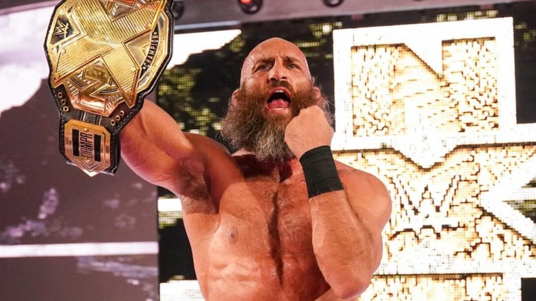 Tommaso Ciampa stands on the stage, holding the NXT Championship after a win on "WWE NXT."