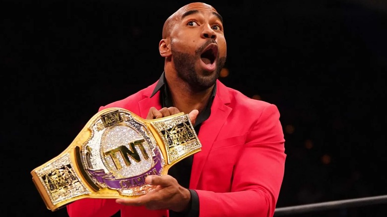 Scorpio Sky proudly holds his AEW TNT Championship during an in-ring promo