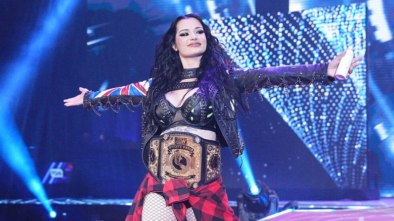Saraya making her way to the ring wearing the AEW Women's World Championship.