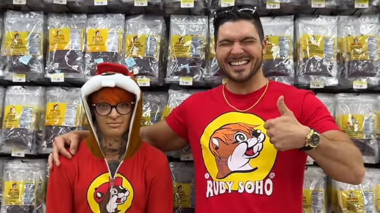 Ruby Soho dressed as Buc-ee the Beaver, standing next to Ethan Page