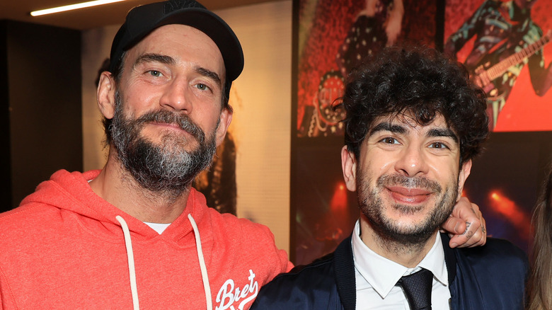 CM Punk arm around Tony Khan