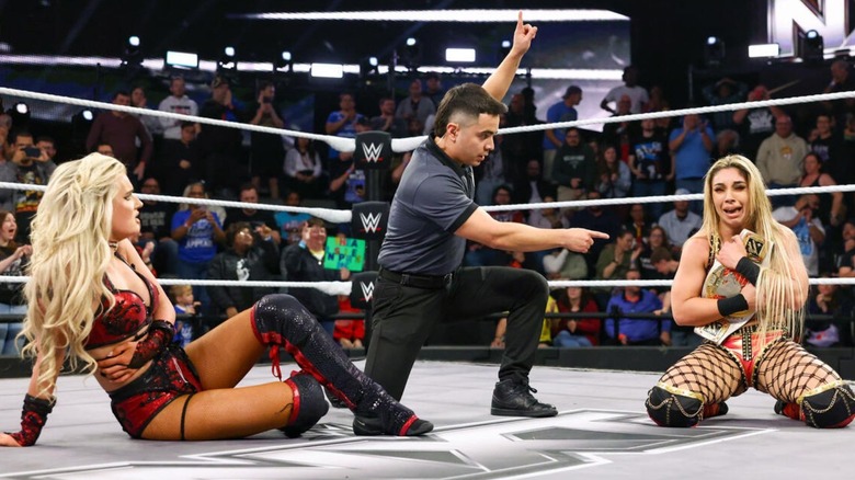 Thea Hail cries, clutching the Women's North American Championship while Blake Monroe looks on confused in the ring during 