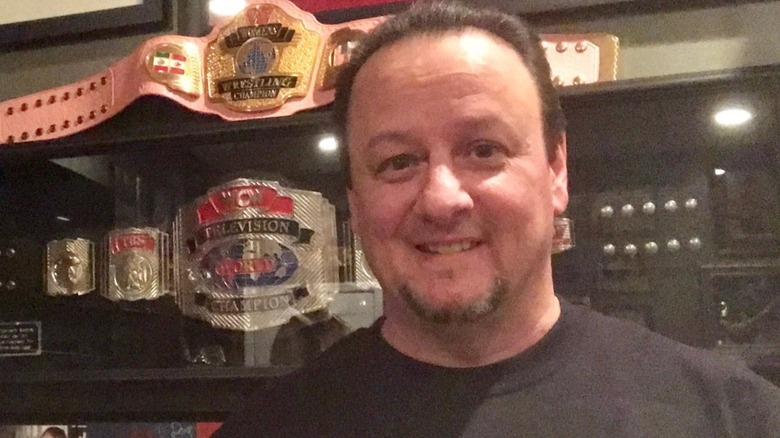Dave Millican posing with belts
