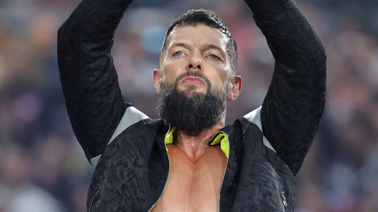 Finn Balor raising up his arms
