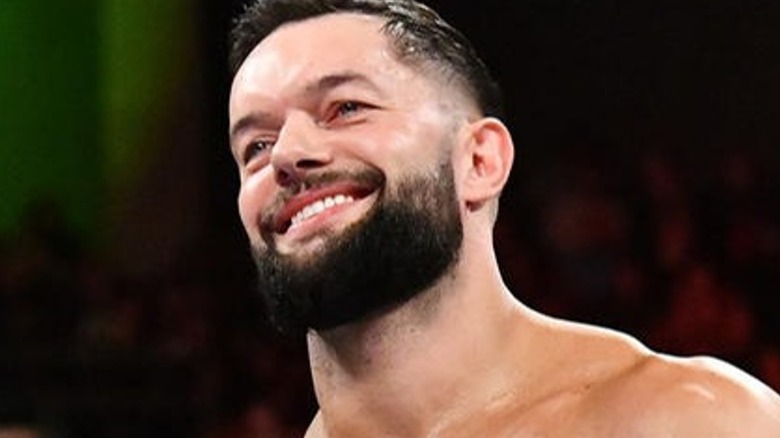 Finn Balor smiling in the ring 
