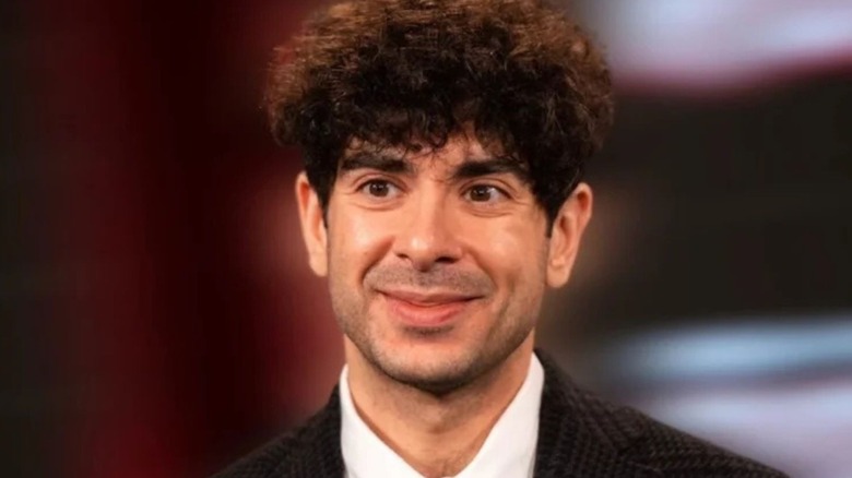 AEW President Tony Khan smiles for the camera during a segment on AEW programming.
