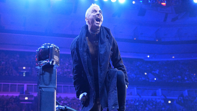 Darby Allin standing on the ring ropes 