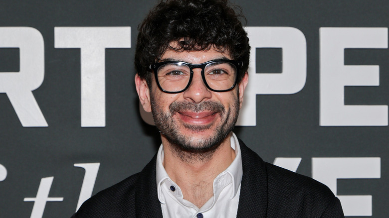 Tony Khan wearing glasses