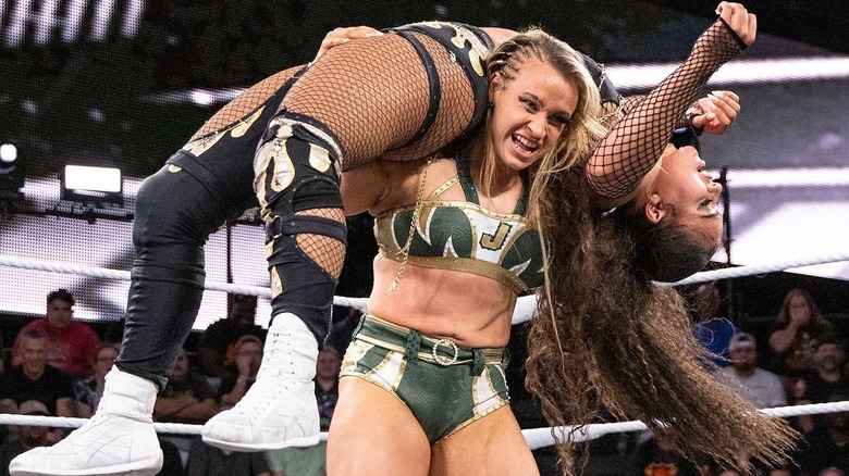 Jordynne Grace hoists up Jaida Parker in a fireman's carry.