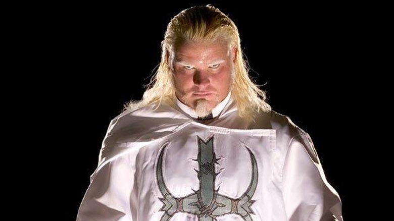 Mordecai posing with his entrance gear for a WWE photoshoot.