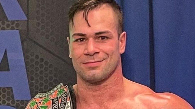 Flip Gordon carrying championship gold