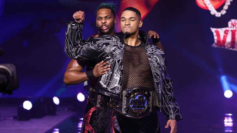 Isiah Kassidy and Marq Quen make their entrance with the AEW World Tag Team Championships.