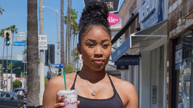 Former WWE star Cameron walking with a drink