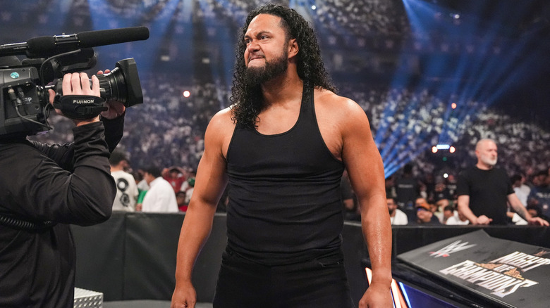 Tala Tonga standing at ringside