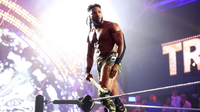 Trick Williams looks to the crowd in the WWE Performance Center while standing on the middle rope before a match on 