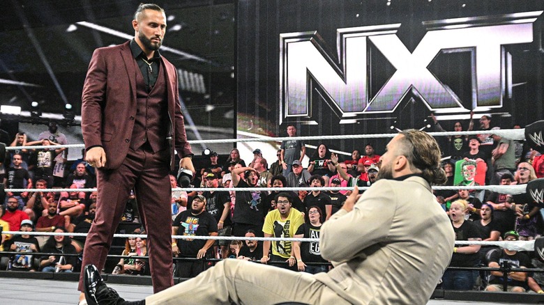 Luca Crusifino knocks Tony D'Angelo down towards the mat with the "WWE NXT" fans looking in awe.