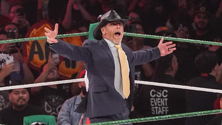 Shawn Michaels, with arms wide open, under the spotlight