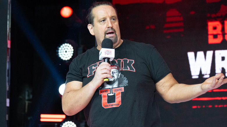 Tommy Dreamer holding a microphone
