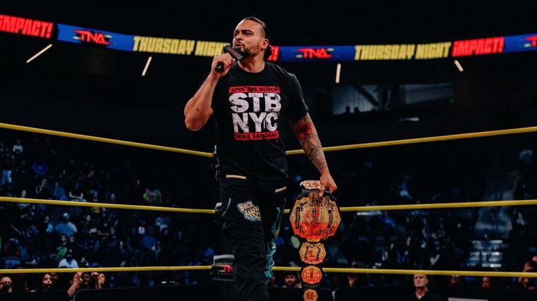 Then-TNA World Champion Mike Santana cuts a promo in the ring, title in hand, during an episode of 