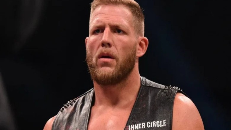 Jake Hager stands in the ring and listens to an opponent cut a promo on an episode of AEW programming.