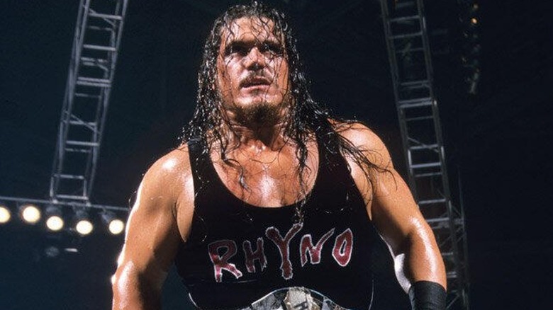 Rhyno standing on top of the turnbuckle with the WWE Harcore Championship around his waist.