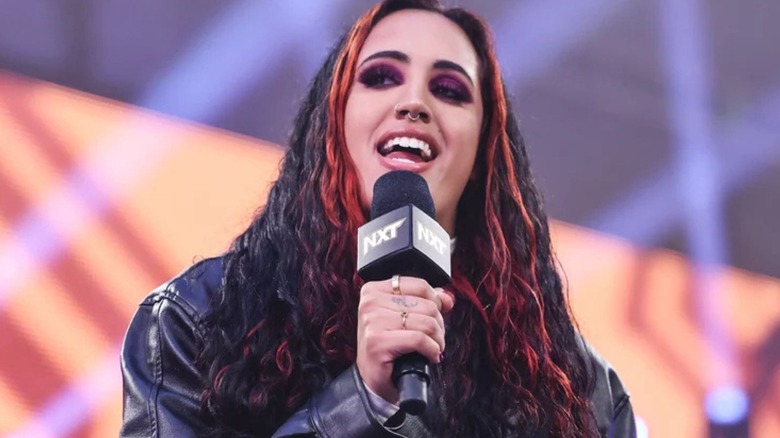"WWE NXT" General Manager Ava makes an announcement in the middle of the ring during a show.