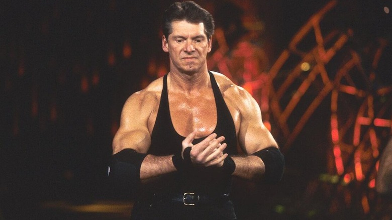 Vince McMahon making his way down to the ring wearing his iconic black singlet.
