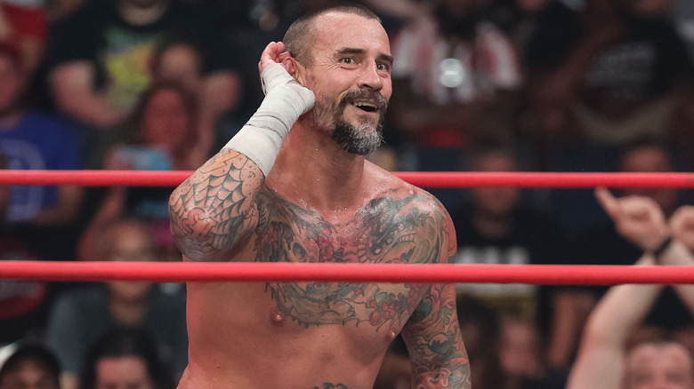 CM Punk posing with his hand cupped to his ear