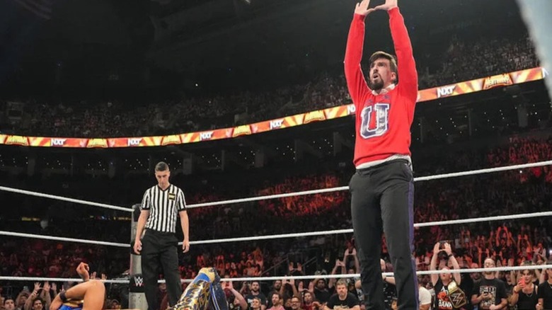 Andre Chase hits his Chase University "U" pose in the ring during a match at "WWE NXT" Heatwave.