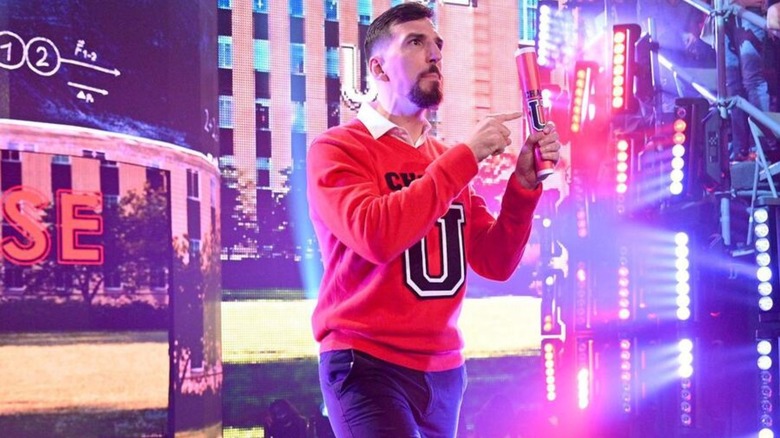 Andre Chase walks down the ramp, Chase University degree in his hand, during a segment on an episode of 