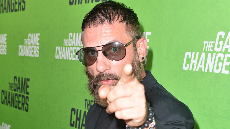 Austin Aries points at the camera during a red carpet event