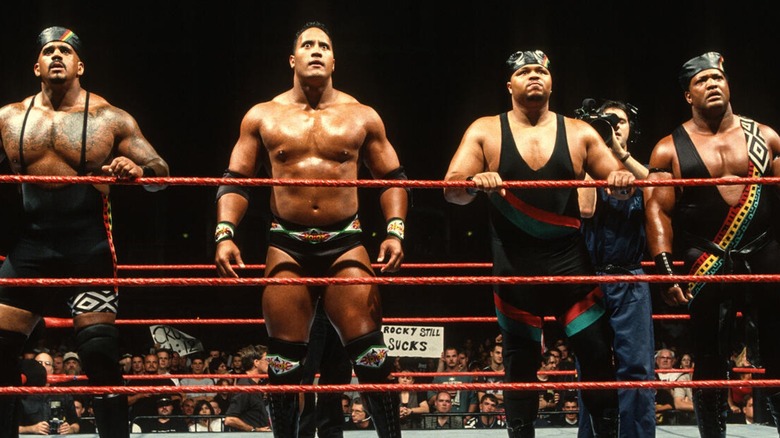 Kama Mustafa (The Godfather), The Rock, D'Lo Brown, and Faarooq as The Nation of Domination.